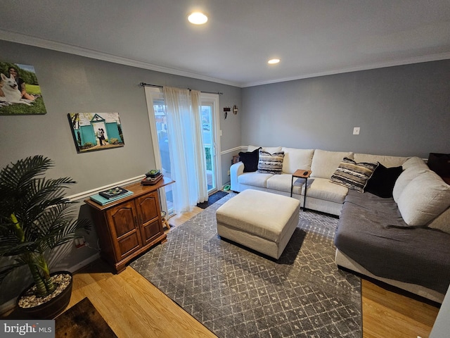 living area with ornamental molding, wood finished floors, and recessed lighting