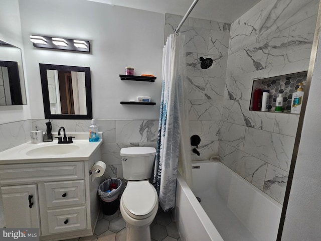 bathroom featuring a wainscoted wall, tile walls, shower / bathtub combination with curtain, toilet, and vanity