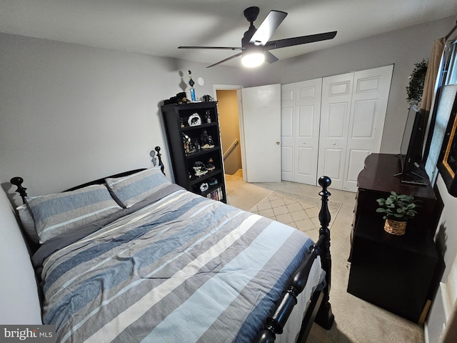 bedroom with ceiling fan and a closet