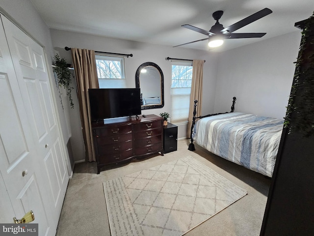 bedroom featuring a ceiling fan and light colored carpet