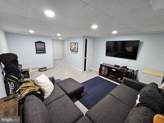 living room featuring baseboards, a drop ceiling, recessed lighting, and light colored carpet