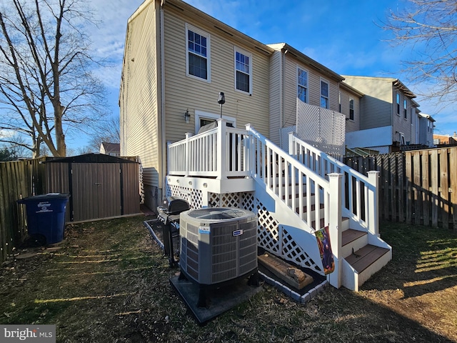 back of house featuring a deck, fence, and central air condition unit