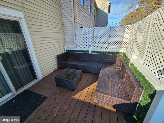 wooden terrace with an outdoor hangout area