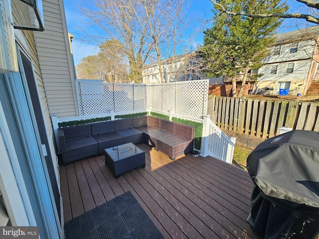 wooden terrace with a grill, an outdoor living space, and fence