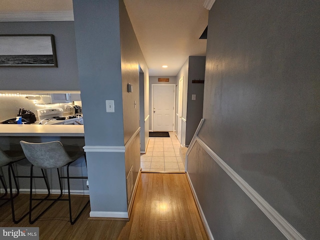 hall featuring light wood-type flooring and baseboards