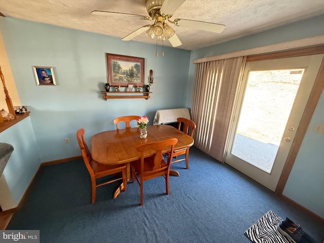 dining space featuring carpet flooring, ceiling fan, and a textured ceiling