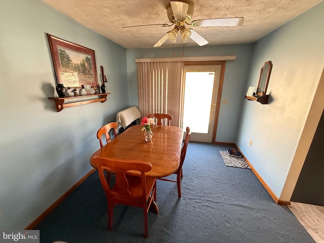 carpeted dining space featuring ceiling fan, a textured ceiling, and baseboards