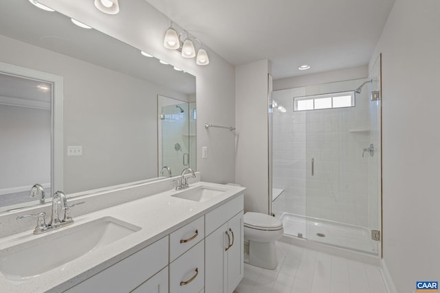 bathroom with a stall shower, a sink, toilet, and double vanity