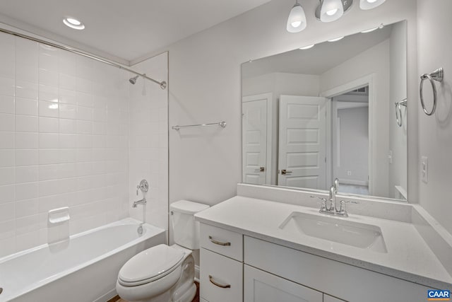 bathroom with toilet, vanity, and bathing tub / shower combination