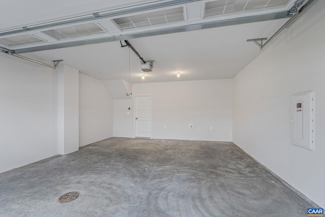 garage with electric panel and a garage door opener