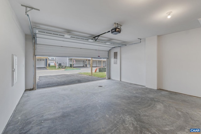 garage featuring a garage door opener and electric panel