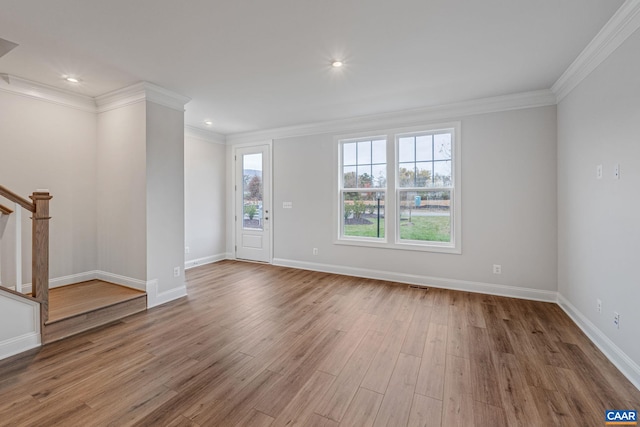 interior space with recessed lighting, wood finished floors, baseboards, stairway, and crown molding