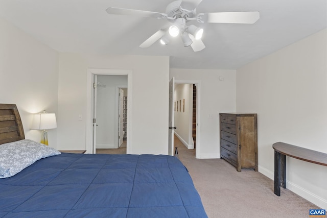 bedroom featuring a ceiling fan, light carpet, and baseboards