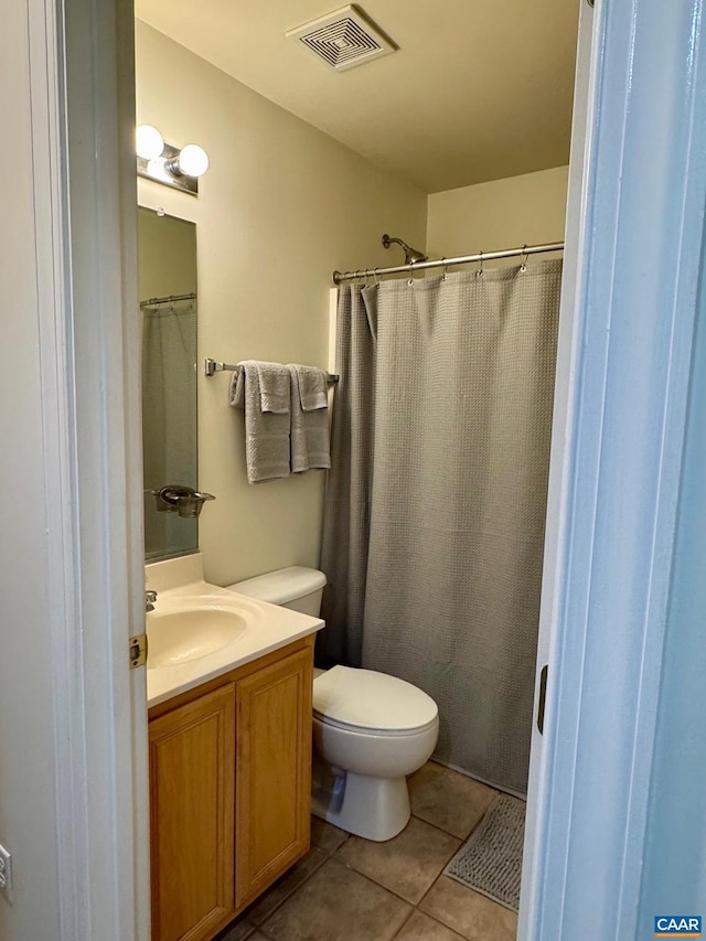 bathroom featuring toilet, tile patterned flooring, visible vents, and vanity