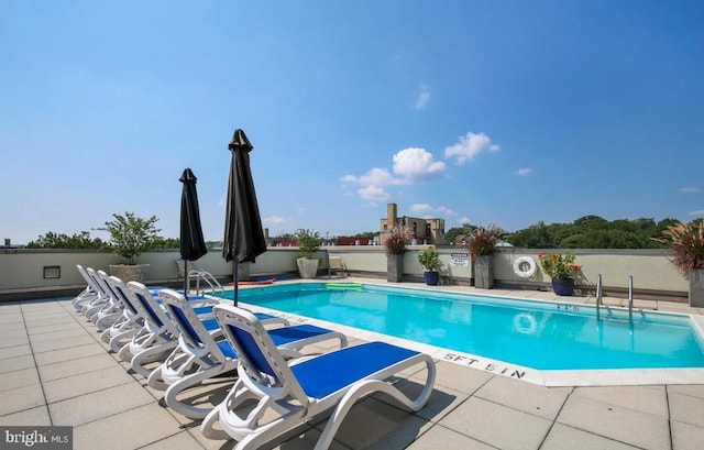 community pool with a patio area