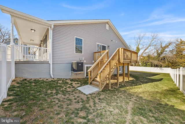 rear view of property with central AC unit, a fenced backyard, stairs, a yard, and a wooden deck