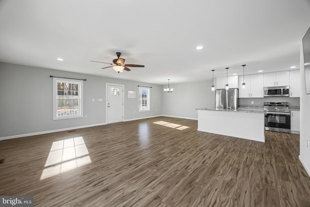 unfurnished living room with baseboards, dark wood-style flooring, and recessed lighting