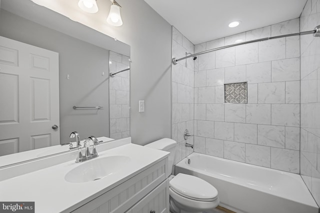 bathroom featuring vanity, toilet, and shower / bathtub combination