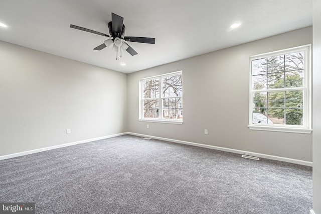 carpeted spare room with visible vents, recessed lighting, a ceiling fan, and baseboards