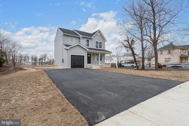 view of front facade with a porch, a residential view, and driveway