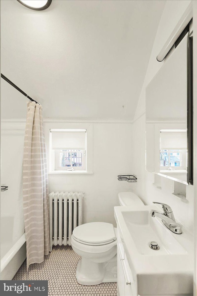 full bath with vaulted ceiling, toilet, a wealth of natural light, and radiator