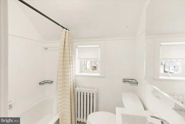 full bathroom featuring lofted ceiling, radiator heating unit, shower / bath combo, and toilet