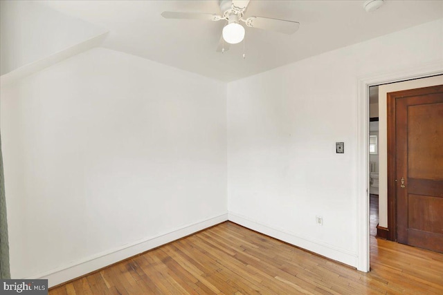 unfurnished room with light wood-type flooring, a ceiling fan, and baseboards