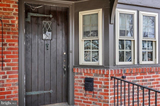 property entrance featuring brick siding