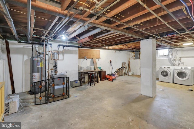 below grade area featuring water heater, a heating unit, and washer and dryer