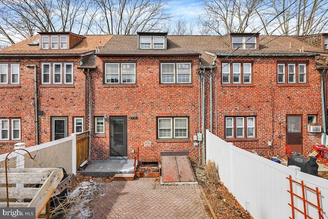 rear view of property with a patio area, a fenced backyard, cooling unit, and brick siding