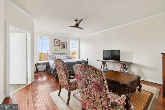 bedroom with ceiling fan, ornamental molding, wood finished floors, and baseboards