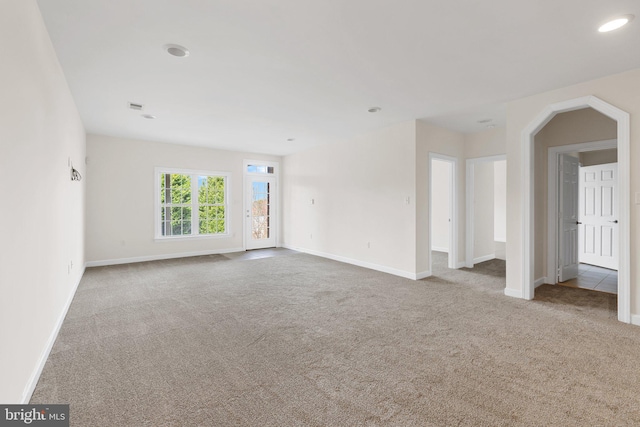 interior space featuring recessed lighting, light carpet, and baseboards