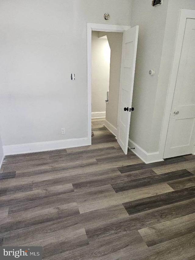 empty room featuring baseboards and wood finished floors