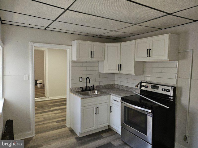 kitchen featuring dark wood-style floors, a sink, white cabinets, and stainless steel electric stove