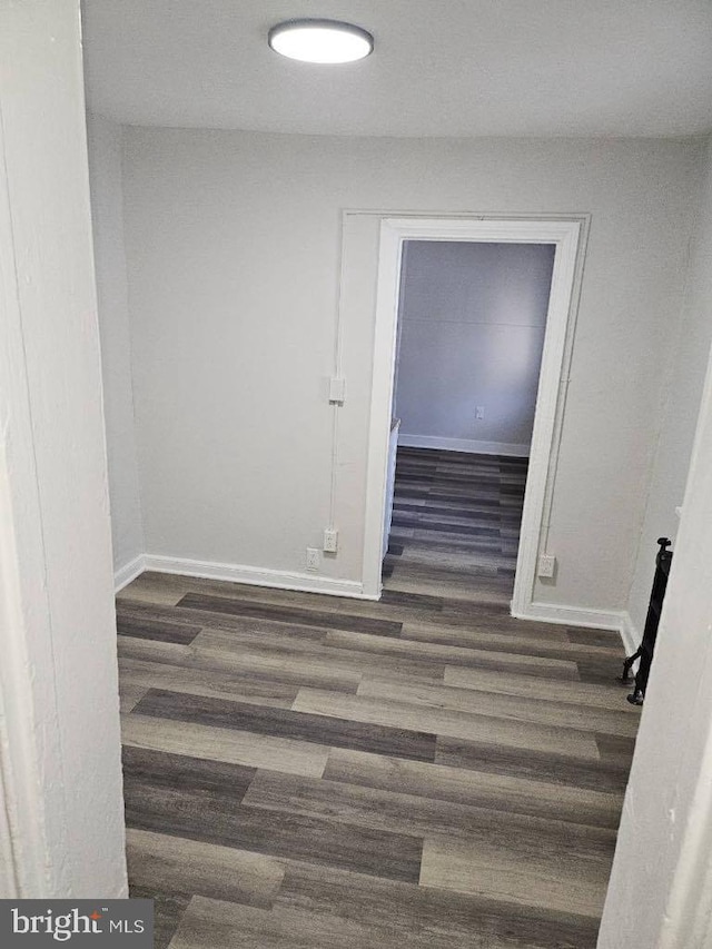 interior space with baseboards and wood finished floors