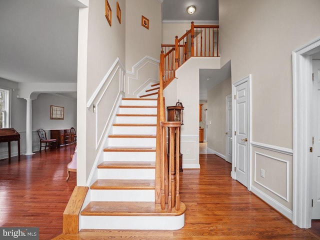 3110 Blackberry Ln, Prince Frederick, MD 20678 - stairway with ornate columns, arched walkways, a high ceiling, and wood finished floors