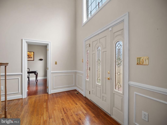 3110 Blackberry Ln, Prince Frederick, MD 20678 - foyer entrance with a decorative wall, a towering ceiling, light wood-style flooring, and a wainscoted wall