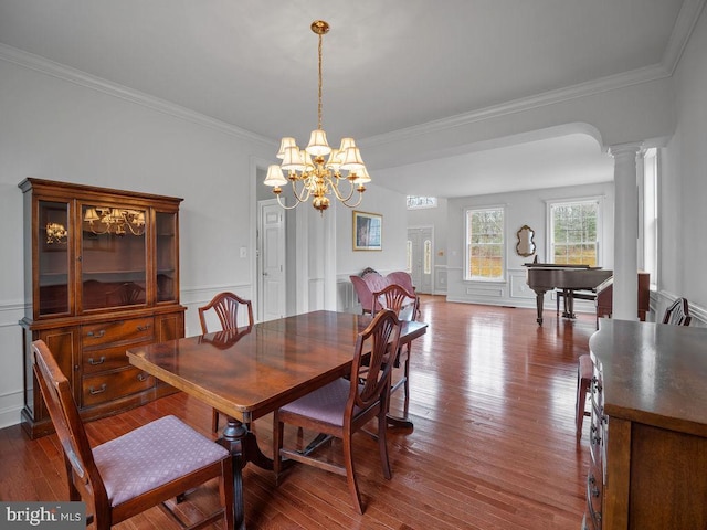 3110 Blackberry Ln, Prince Frederick, MD 20678 - dining room featuring a notable chandelier, ornate columns, ornamental molding, and wood finished floors