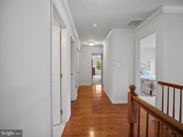 3110 Blackberry Ln, Prince Frederick, MD 20678 - hallway featuring crown molding, light wood-style flooring, visible vents, an upstairs landing, and baseboards