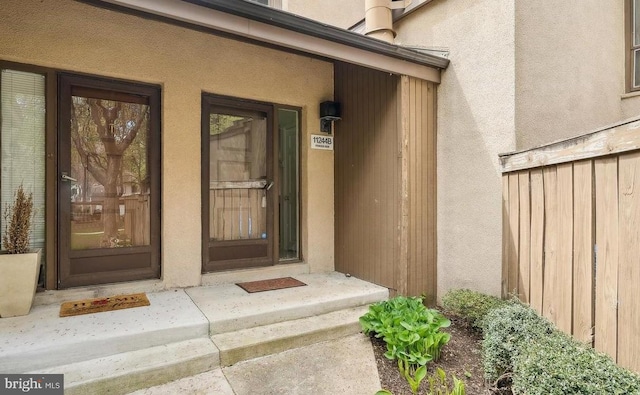 property entrance with stucco siding