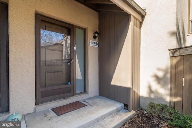 view of exterior entry featuring stucco siding