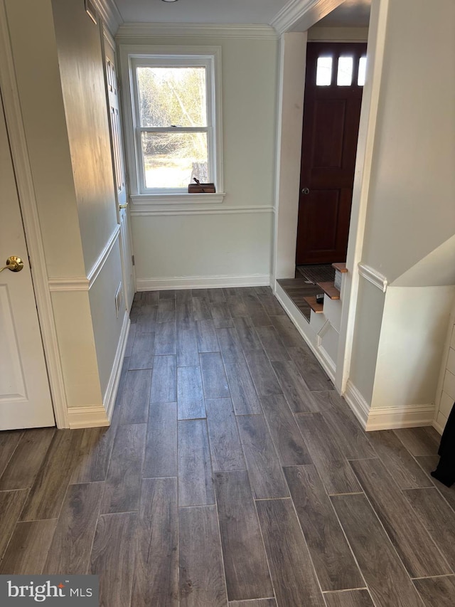 entrance foyer with ornamental molding, wood tiled floor, and baseboards