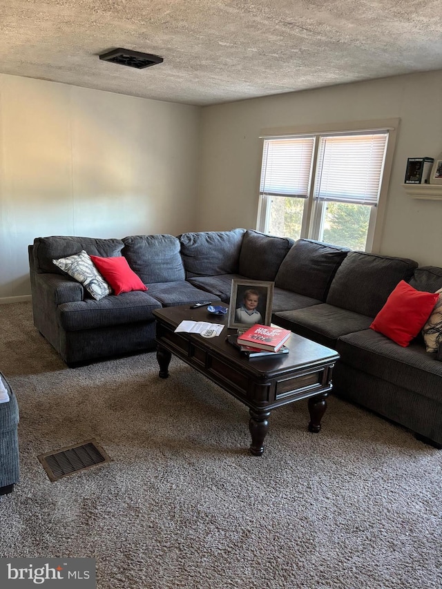 carpeted living room featuring visible vents and a textured ceiling