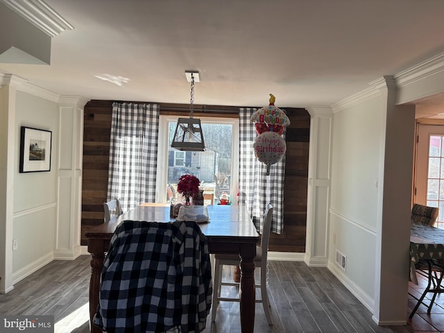 dining area with dark wood-style floors, ornamental molding, visible vents, and baseboards