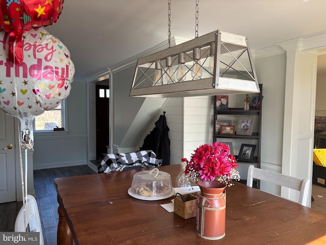 dining space with dark wood-style floors and crown molding