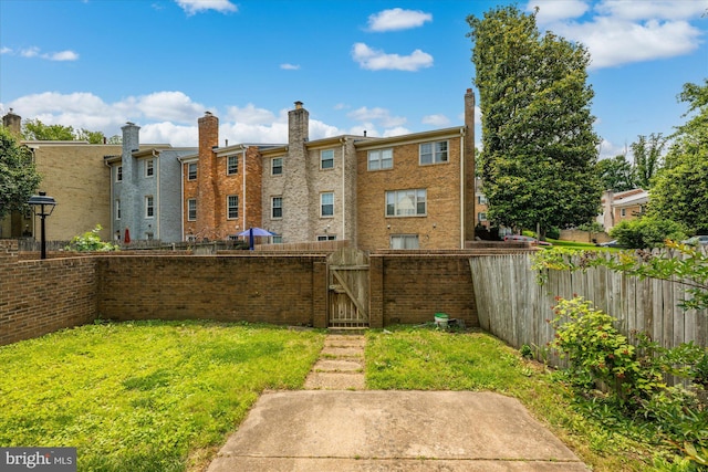 7349 Eldorado Ct, Mclean, VA 22102 - back of house with a gate, brick siding, and a chimney