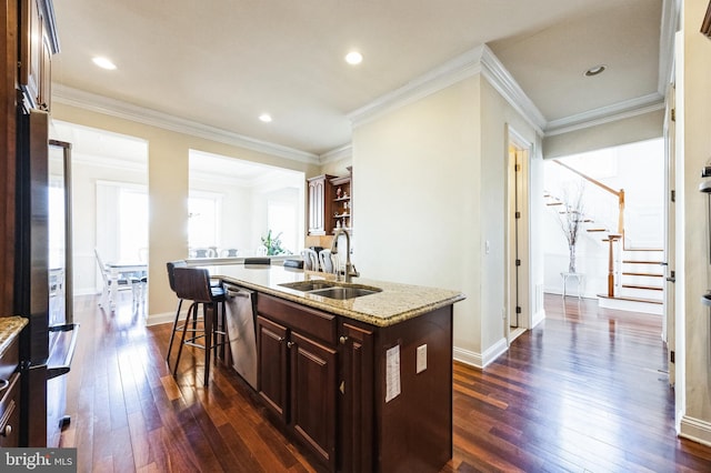 kitchen featuring dark wood finished floors, dishwasher, an island with sink, ornamental molding, and a sink