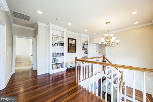 corridor with ornamental molding, dark wood-style flooring, an upstairs landing, and visible vents