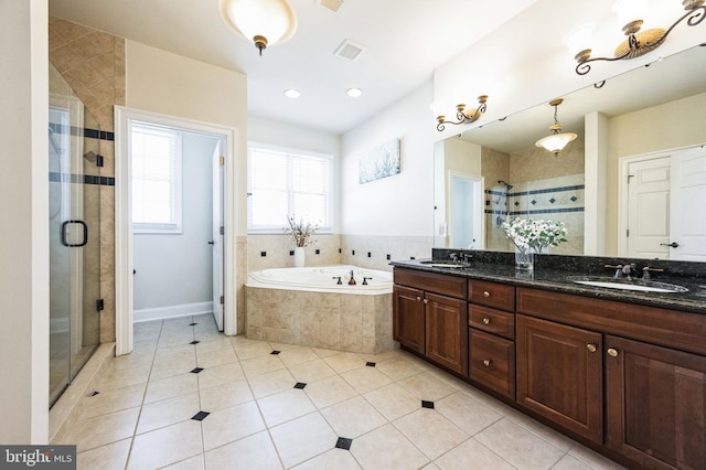 full bath featuring a garden tub, a sink, a shower stall, tile patterned floors, and double vanity