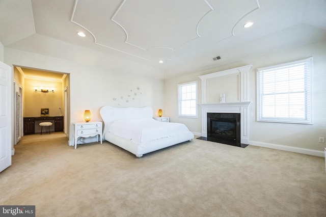 carpeted bedroom with a fireplace with flush hearth, recessed lighting, visible vents, and baseboards